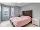 Cozy bedroom featuring two windows, a wooden bed frame, and grey walls at 5075 Weeping Willow Cir, Highlands Ranch, CO 80130