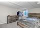 Bedroom features a wooden bed frame, grey comforter, six-drawer dresser and window at 5075 Weeping Willow Cir, Highlands Ranch, CO 80130