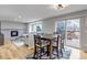 The dining room features an area rug, wooden table with seating, and access to the outdoor deck at 5075 Weeping Willow Cir, Highlands Ranch, CO 80130