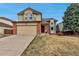 Welcoming two-story home with a two-car garage, brick details, and an inviting front entrance at 5075 Weeping Willow Cir, Highlands Ranch, CO 80130