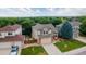 Aerial view of a charming two-story home with a well-maintained front yard, landscaped garden, and a two-car garage at 5075 Weeping Willow Cir, Highlands Ranch, CO 80130
