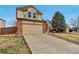 Charming two-story home with a spacious two-car garage, brick accents, and manicured landscaping at 5075 Weeping Willow Cir, Highlands Ranch, CO 80130