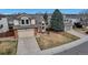 Charming home with a two-car garage, brick accents, and a well-manicured lawn at 5075 Weeping Willow Cir, Highlands Ranch, CO 80130