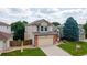 Lovely two-story home featuring an attached garage, well-kept lawn, and charming curb appeal at 5075 Weeping Willow Cir, Highlands Ranch, CO 80130