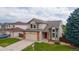 Beautiful two-story home with a well-manicured lawn, and an attached two-car garage at 5075 Weeping Willow Cir, Highlands Ranch, CO 80130