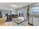 Open concept kitchen with a dining table, fireplace, and sliding door to a deck at 5075 Weeping Willow Cir, Highlands Ranch, CO 80130