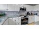 Modern kitchen features granite counters, stainless steel appliances, and white cabinets at 5075 Weeping Willow Cir, Highlands Ranch, CO 80130