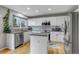 Bright kitchen with white cabinets, granite countertops, stainless steel appliances, and center island at 5075 Weeping Willow Cir, Highlands Ranch, CO 80130