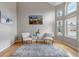 Sunlit living room featuring hardwood floors, a large window, and neutral decor at 5075 Weeping Willow Cir, Highlands Ranch, CO 80130