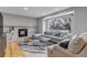 Inviting living room with a fireplace, large windows, and comfortable seating at 5075 Weeping Willow Cir, Highlands Ranch, CO 80130