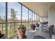 Relaxing enclosed balcony features flowers, an outdoor seating area, and expansive views at 1201 N Williams St # 4C, Denver, CO 80218