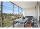 Large, screened-in balcony perfect for outdoor dining with city and park views at 1201 N Williams St # 4C, Denver, CO 80218