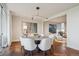 Bright dining room features a modern chandelier, herringbone floors, and an adjacent living area at 1201 N Williams St # 4C, Denver, CO 80218