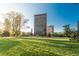 Beautiful building with expansive green space, landscaping, and city views on a sunny day at 1201 N Williams St # 4C, Denver, CO 80218