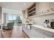 Stylish kitchen with stainless steel sink, quartz countertops, and open shelving at 1201 N Williams St # 4C, Denver, CO 80218