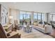 Bright and spacious living room with a balcony overlooking a lush green landscape and city views at 1201 N Williams St # 4C, Denver, CO 80218