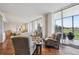 Sun-drenched living space with hardwood floors, stylish furniture, and access to an outdoor balcony at 1201 N Williams St # 4C, Denver, CO 80218
