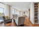 Expansive living area with plush seating, herringbone floors, and sliding doors to a balcony at 1201 N Williams St # 4C, Denver, CO 80218