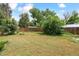 Private, fully fenced back yard with mature trees and established grass at 1708 Akron St, Aurora, CO 80010