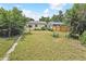 Spacious back yard with alley access, mature landscaping, and a private fence at 1708 Akron St, Aurora, CO 80010