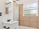 Stylish bathroom featuring tiled shower and vanity with black hardware at 1708 Akron St, Aurora, CO 80010