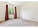 This bedroom features a window overlooking a tree-lined property at 1708 Akron St, Aurora, CO 80010