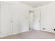 Neutral bedroom showcasing two doors and a large window at 1708 Akron St, Aurora, CO 80010