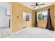 Dining area features neutral paint, new ceiling fan, carpet and a view into the kitchen at 1708 Akron St, Aurora, CO 80010