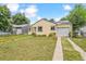 Charming single-story home with a well-maintained front lawn, driveway and attached garage at 1708 Akron St, Aurora, CO 80010