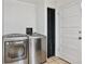 Functional laundry area with stainless steel washer and dryer units at 1708 Akron St, Aurora, CO 80010