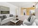 Bright living room features neutral decor and a seamless flow into the adjacent dining area at 1708 Akron St, Aurora, CO 80010