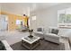 Bright living room featuring new decor flows into the adjacent dining area, and kitchen at 1708 Akron St, Aurora, CO 80010