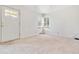 Bright living room features neutral paint, ample natural light, and newer carpet at 1708 Akron St, Aurora, CO 80010