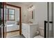 Bright bathroom features white vanity, modern lighting, and leads to an adjacent bedroom with a scenic view at 34 Highfield Trl # 307, Breckenridge, CO 80424