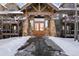 View of the front entrance to the condominium complex featuring stone columns and a heavy timber gable at 34 Highfield Trl # 307, Breckenridge, CO 80424