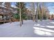 Winter landscape with a tree line next to condominium complex at 34 Highfield Trl # 307, Breckenridge, CO 80424