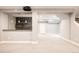 Finished basement with a wet bar, projector, and open space at 3473 Beeler St, Denver, CO 80238
