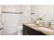 Bathroom with granite double vanity, tub and shower with decorative tile accent at 3473 Beeler St, Denver, CO 80238