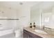 Bathroom with granite countertop, decorative vases, large mirror, white shower, and white toilet at 3473 Beeler St, Denver, CO 80238