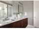 Modern bathroom with double sinks, granite countertops, and decorative tiling at 3473 Beeler St, Denver, CO 80238