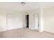 Bright bedroom featuring neutral carpet, base trim, closet and open doors to the hallway and bathroom at 3473 Beeler St, Denver, CO 80238