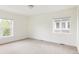 Bright bedroom with two windows providing natural light and neutral carpet at 3473 Beeler St, Denver, CO 80238