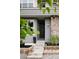 Charming home exterior with stone accents, well-maintained landscaping, and steps to the black front door at 3473 Beeler St, Denver, CO 80238