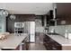 Well-equipped kitchen with stainless steel appliances, an island with sink, and a mosaic backsplash at 3473 Beeler St, Denver, CO 80238
