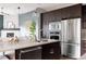 Open kitchen design with stainless steel appliances, a large island, and an adjacent dining area at 3473 Beeler St, Denver, CO 80238