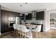 Stylish kitchen with dark cabinets, stainless steel appliances, and a center island with pendant lighting at 3473 Beeler St, Denver, CO 80238