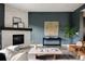 Cozy living room with a white-washed fireplace, mantel, and stylish decor accents at 3473 Beeler St, Denver, CO 80238