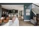 Open concept living room, dark accent wall, staircase, leading into the kitchen with a view to the dining area at 3473 Beeler St, Denver, CO 80238