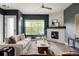 Bright living room featuring a stone fireplace, a large window, and comfortable seating area at 3473 Beeler St, Denver, CO 80238