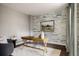 Bright office space with a rustic wooden desk, accent wall, and dark hardwood floors at 3473 Beeler St, Denver, CO 80238